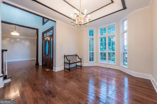 a spacious bathroom with a granite countertop double vanity and a sink