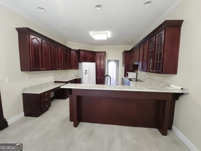a kitchen with a refrigerator and a sink