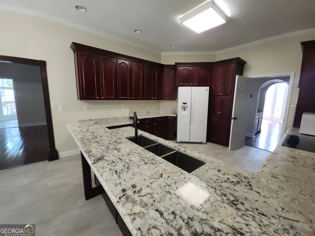 a kitchen with stainless steel appliances granite countertop wooden cabinets a sink and dishwasher
