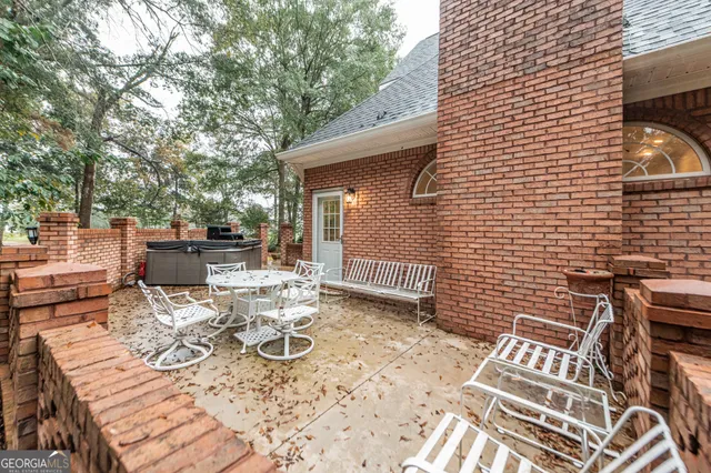 a view of a patio with couches chairs and wooden floor
