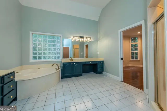 a view of room with a ceiling fan and a window