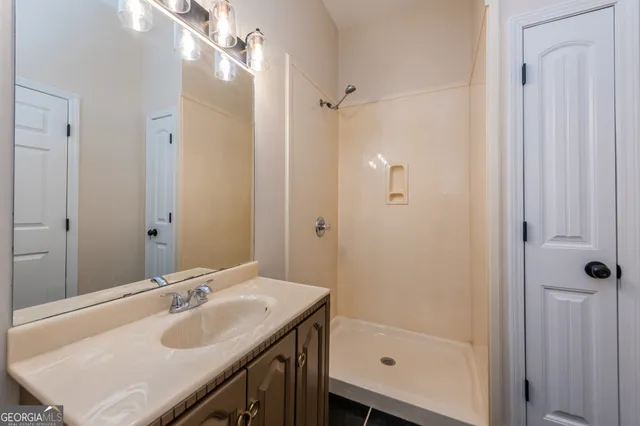 a view of a yard with a house and a large tree