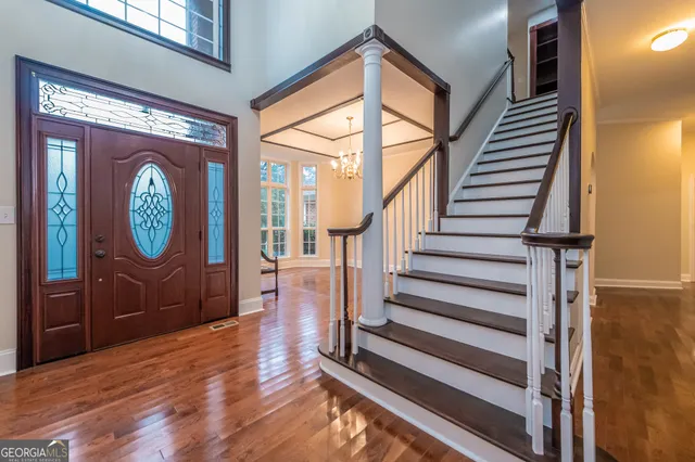 a view of a room with wooden floor and a window