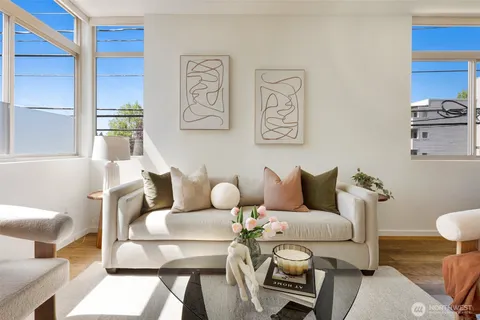 a living room with furniture and a painting on the wall