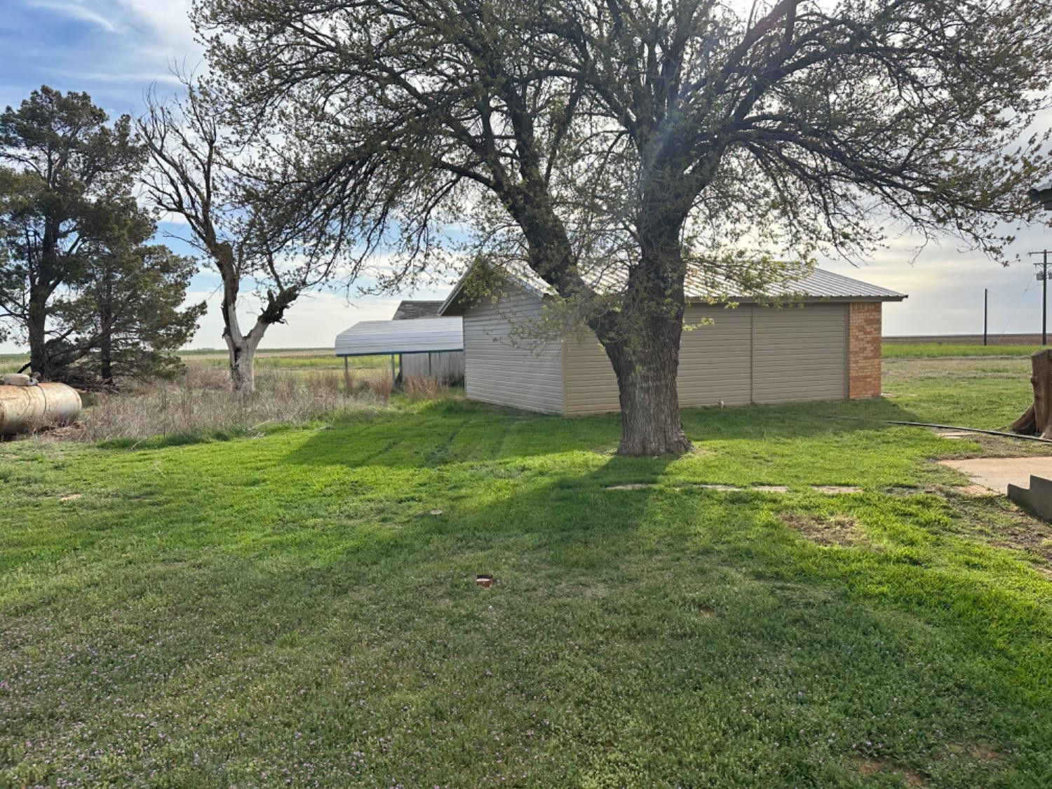 621 County Road 280 Post, TX 79356 - Photo 7 of 17 a view of a house with yard and tree s