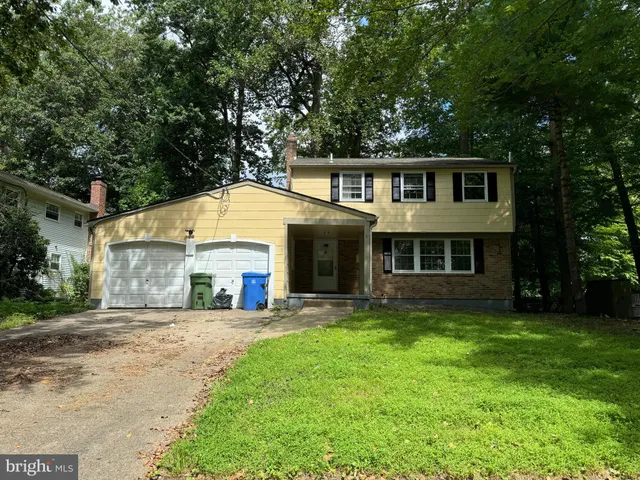 a front view of a house with a yard and porch