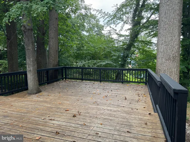 a view of balcony with wooden floor and fence