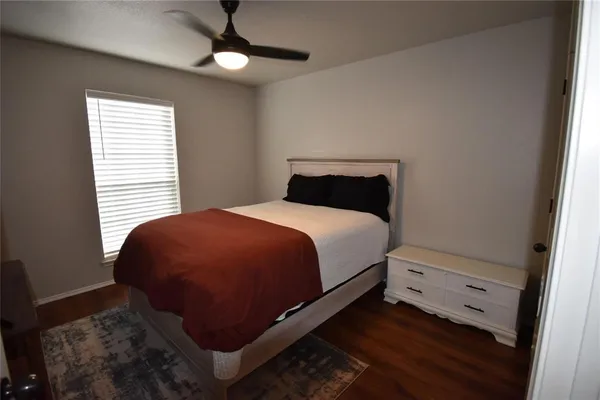 a bed sitting in a bedroom next to a window
