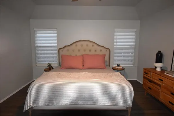 a bathroom with a granite countertop sink a mirror and a bathtub