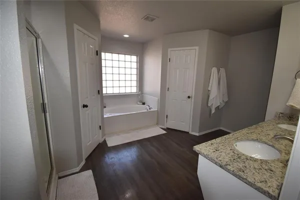a bathroom with a granite countertop sink and a mirror