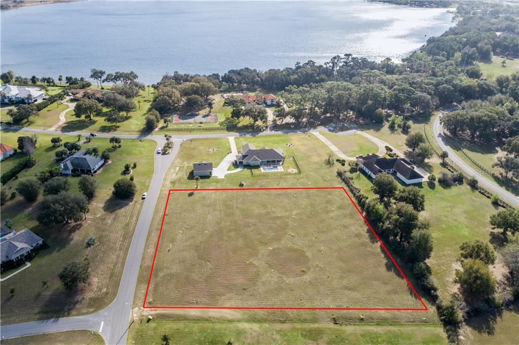 Desirable shaped lot with views of the lake, paved road frontage and surrounded by large conventional homes.