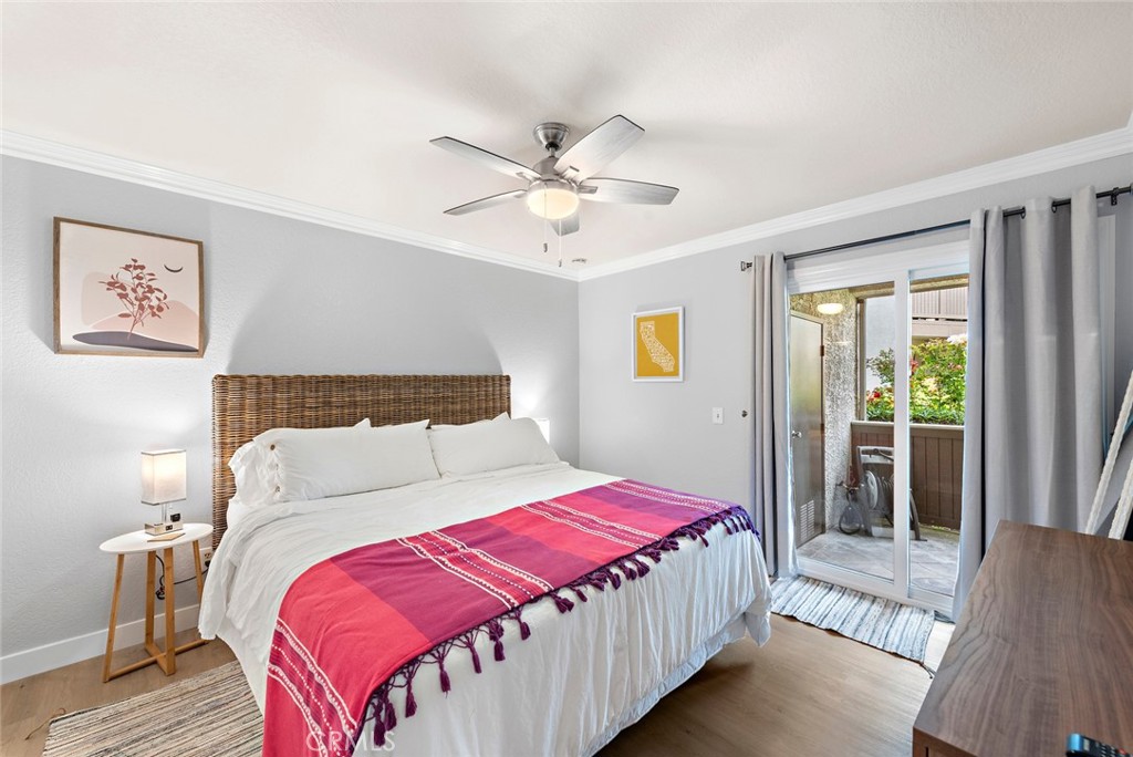 70 Corniche Drive, Unit A Dana Point, CA 92629 - Photo 13 of 27 a bedroom with a large bed and a chandelier