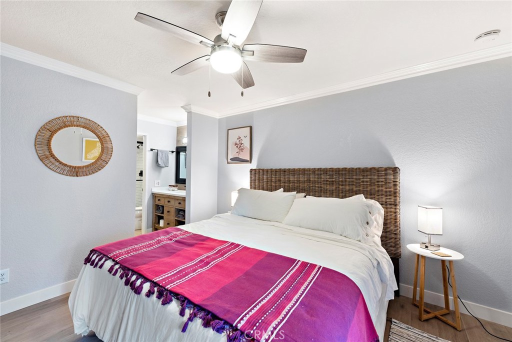 70 Corniche Drive, Unit A Dana Point, CA 92629 - Photo 15 of 27 a bedroom with a bed and a chandelier