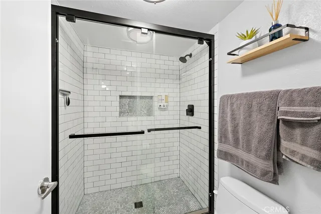 a bathroom with a shower and a sink