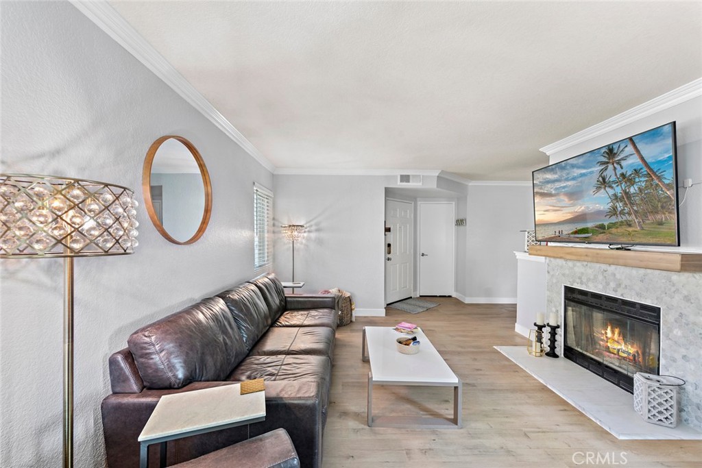 70 Corniche Drive, Unit A Dana Point, CA 92629 - Photo 4 of 27 a living room with furniture a window and a fireplace