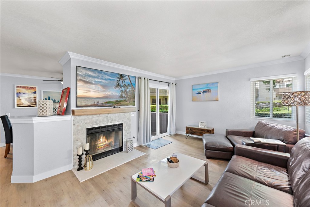 70 Corniche Drive, Unit A Dana Point, CA 92629 - Photo 5 of 27 a living room with furniture and a fireplace