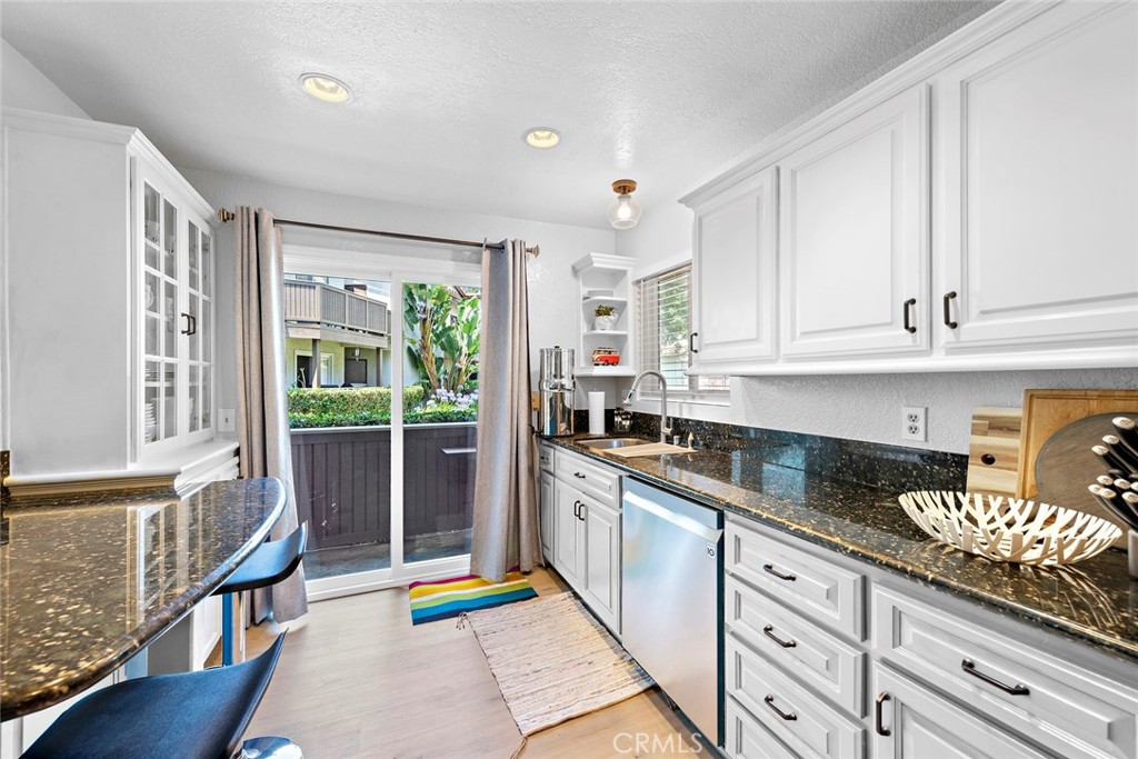 70 Corniche Drive, Unit A Dana Point, CA 92629 - Photo 9 of 27 a kitchen with granite countertop stainless steel appliances a stove a sink and cabinets