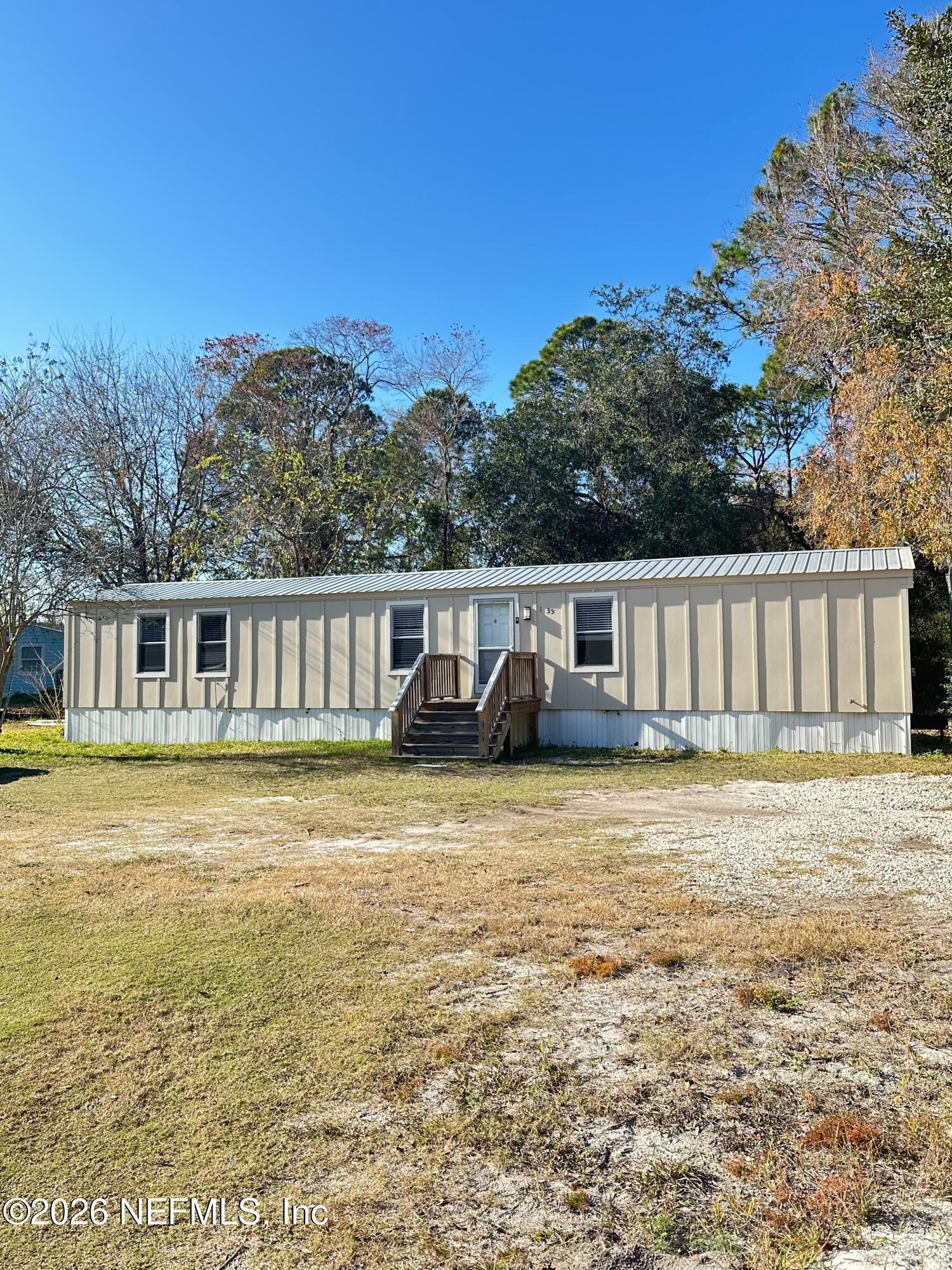 1635 Natalie Road St. Augustine, FL 32084 - Photo 1 of 16 a front view of a house with a garden