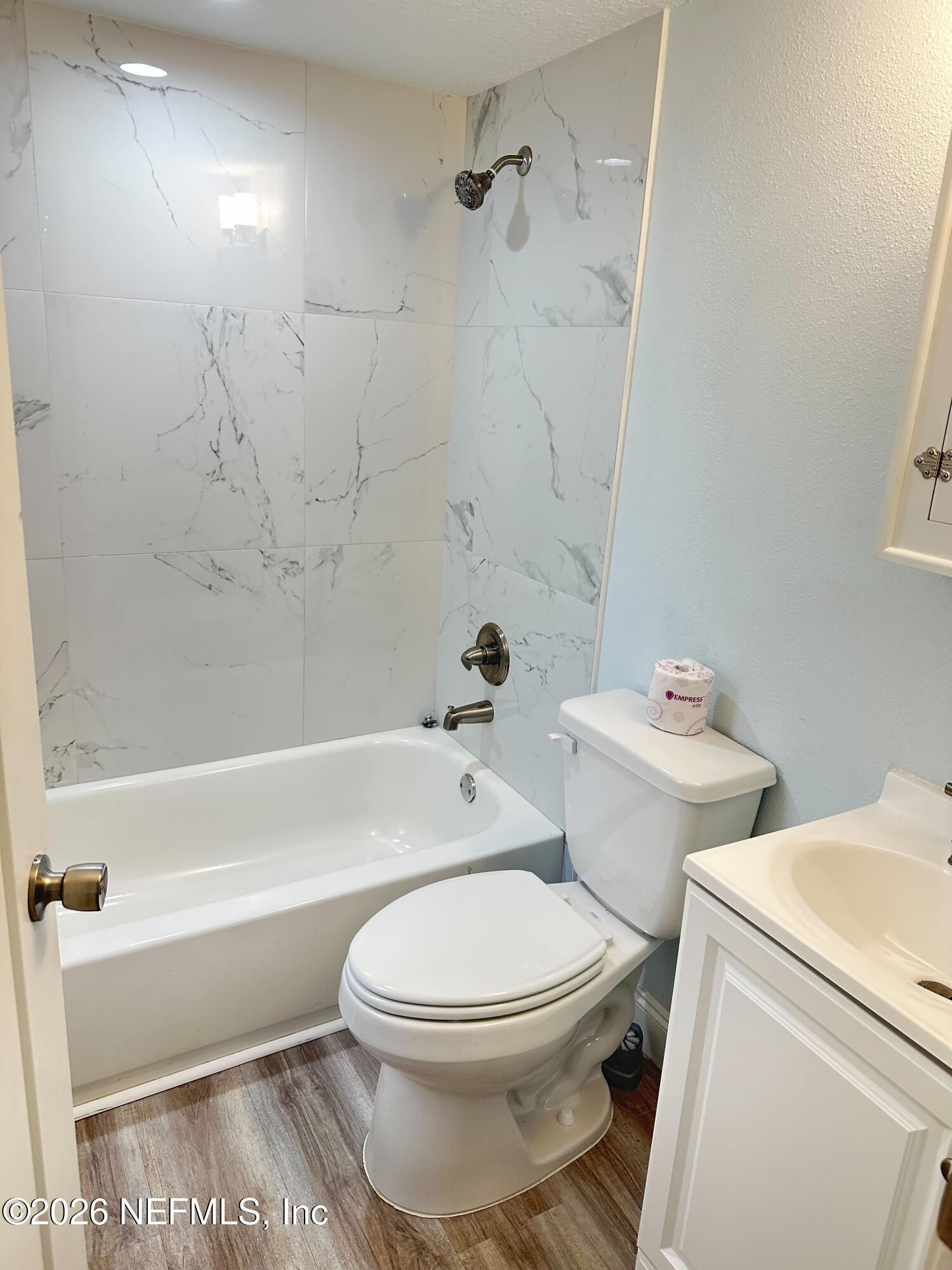 1635 Natalie Road St. Augustine, FL 32084 - Photo 14 of 16 a white toilet and tub sitting next to a bathroom sink