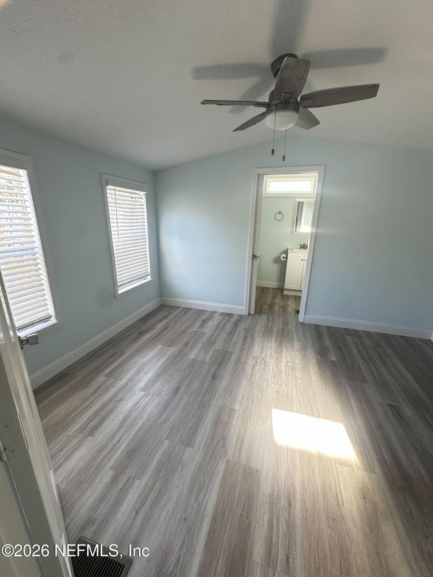 1635 Natalie Road St. Augustine, FL 32084 - Photo 3 of 16 wooden floor in an empty room with a window