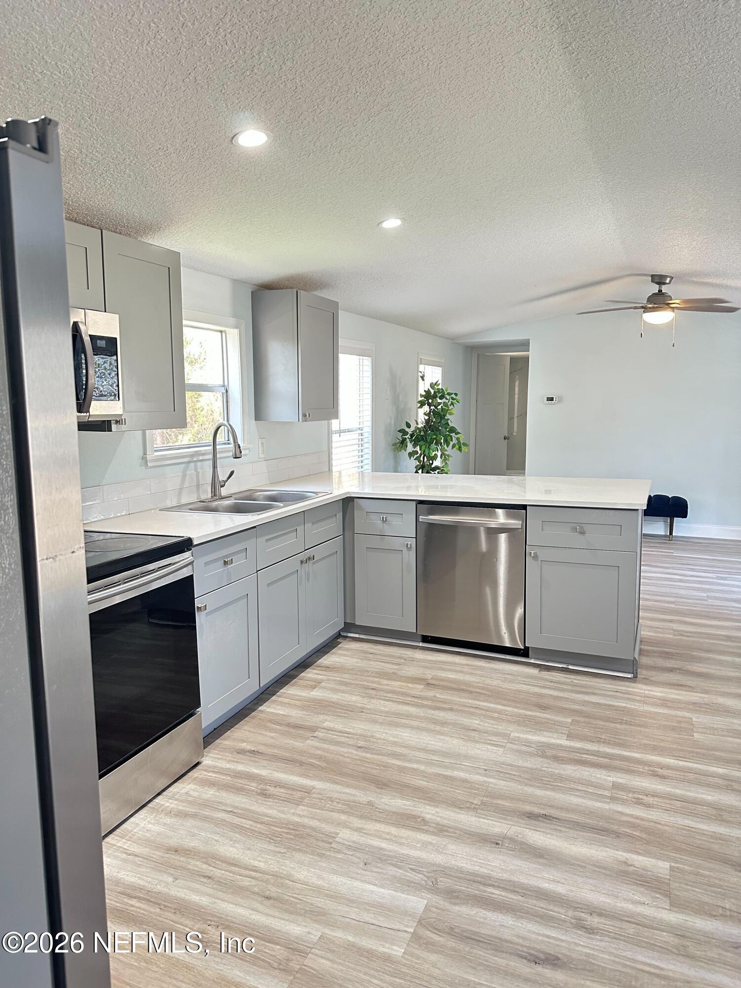 1635 Natalie Road St. Augustine, FL 32084 - Photo 5 of 16 a large kitchen with stainless steel appliances granite countertop a sink and cabinets