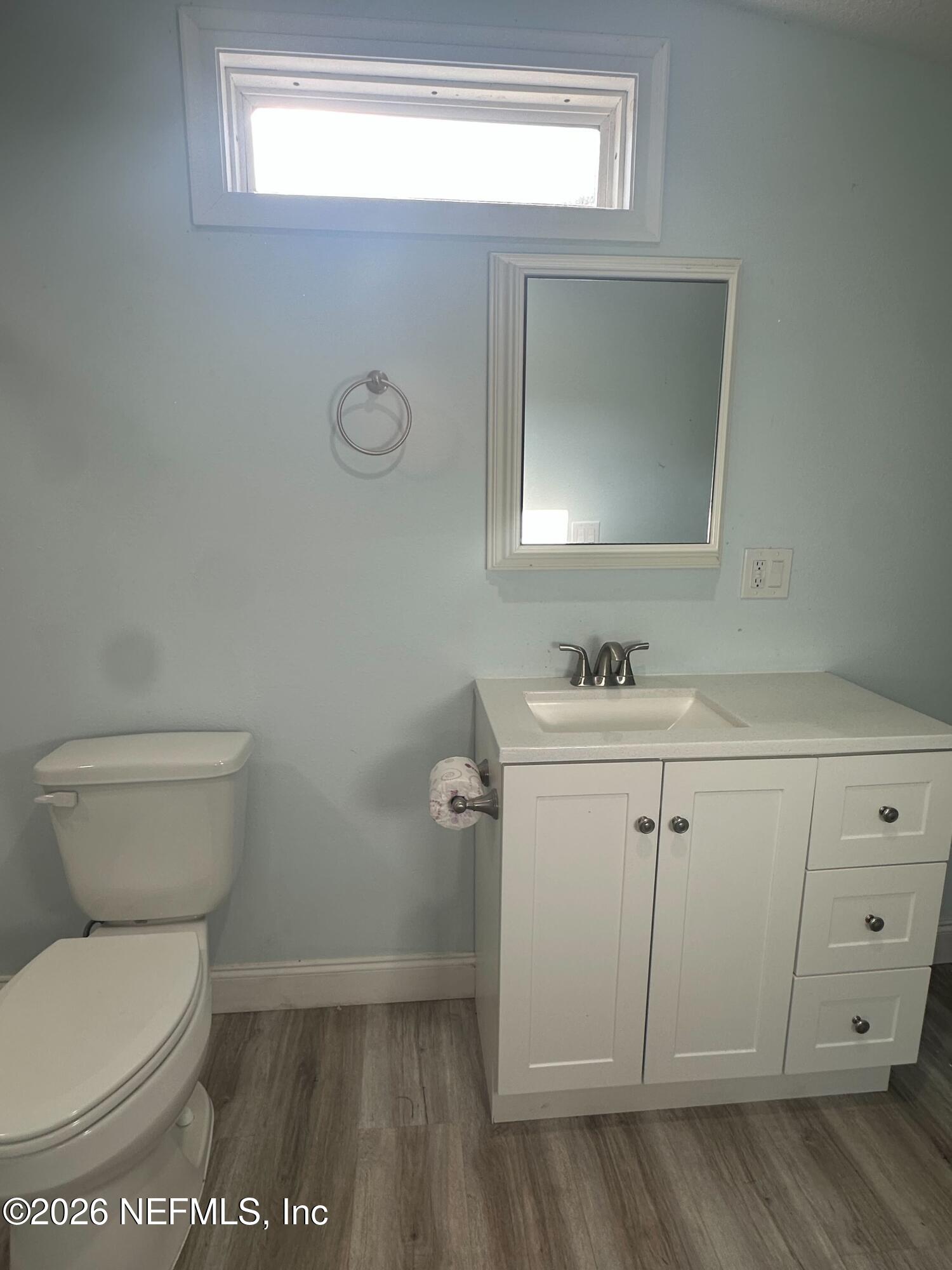 1635 Natalie Road St. Augustine, FL 32084 - Photo 7 of 16 a bathroom with a toilet sink and mirror