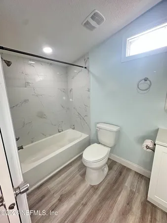 a bathroom with a toilet a sink and a bathtub