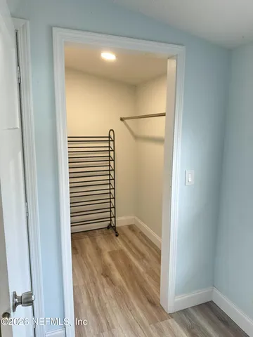 a view of a bathroom with wooden floor