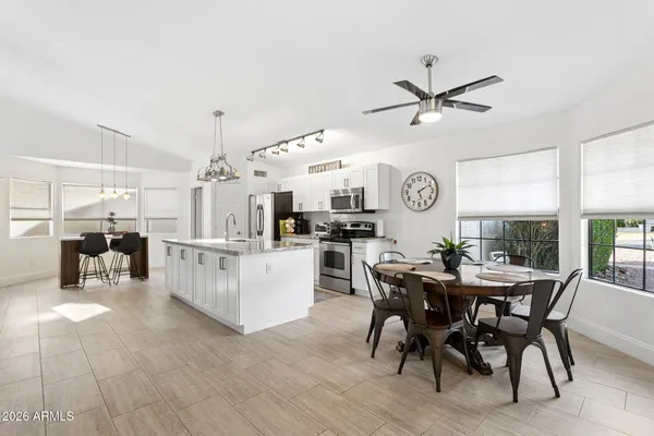 a kitchen with stainless steel appliances white cabinets white stove a microwave and a refrigerator