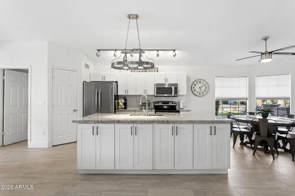 a view of a kitchen center island and living room