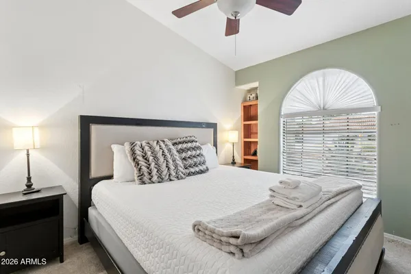 a bedroom with a bed and a window