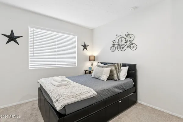 a bedroom with a bed and a chair