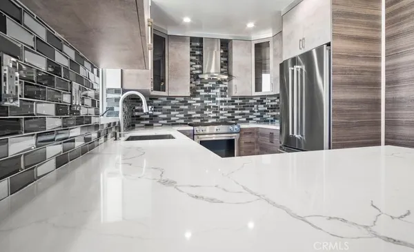 a kitchen with stainless steel appliances a refrigerator and a sink