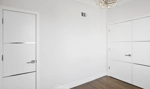 a view of a closet with wooden floor