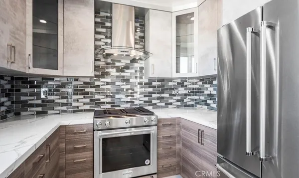a kitchen with stainless steel appliances a stove and a refrigerator