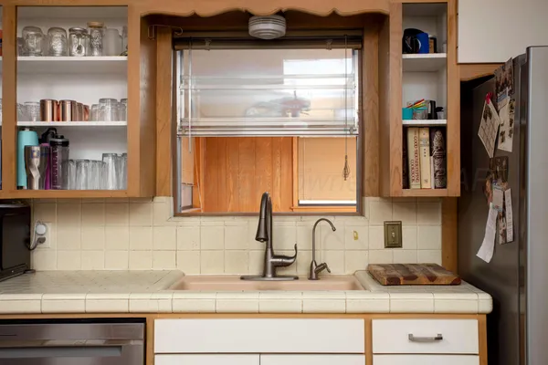 a kitchen with stainless steel appliances granite countertop a sink and cabinets
