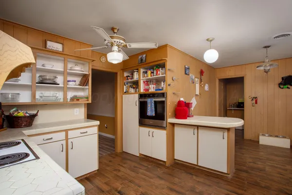 a kitchen view with stainless steel appliances kitchen island granite countertop a table and chairs in it