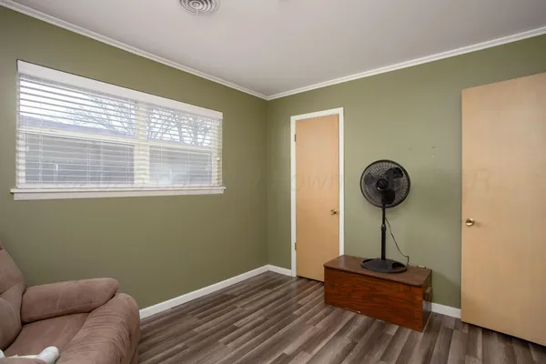 a room with a window and wooden floor