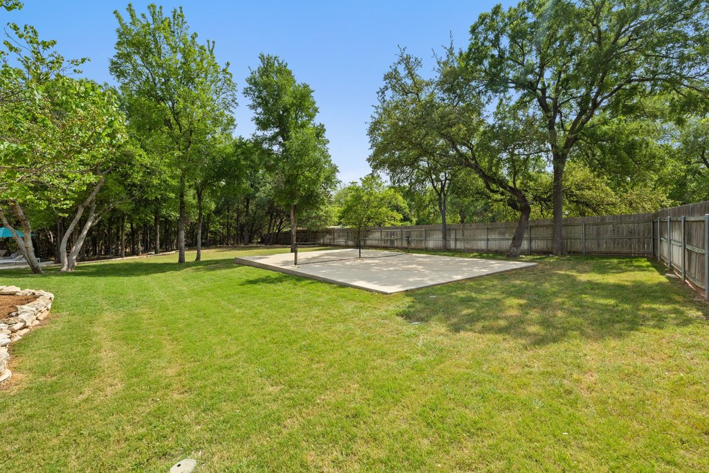 108 Berry Cove Georgetown, TX 78628 - Photo 32 of 39 a swimming pool with trees in the background
