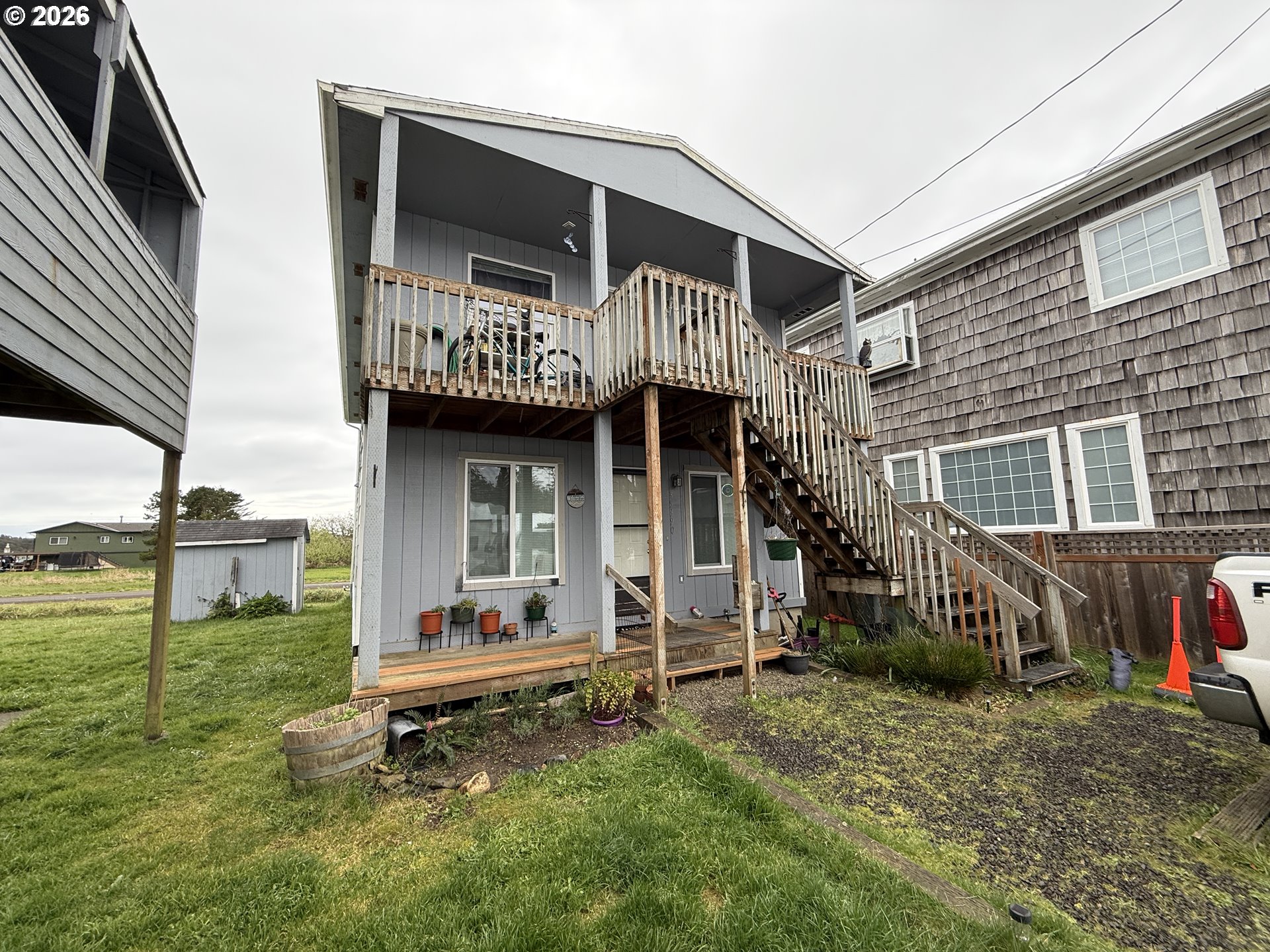 35390 Brooten Road Pacific City, OR 97135 - Photo 4 of 19 a front view of a house with a garden and chair