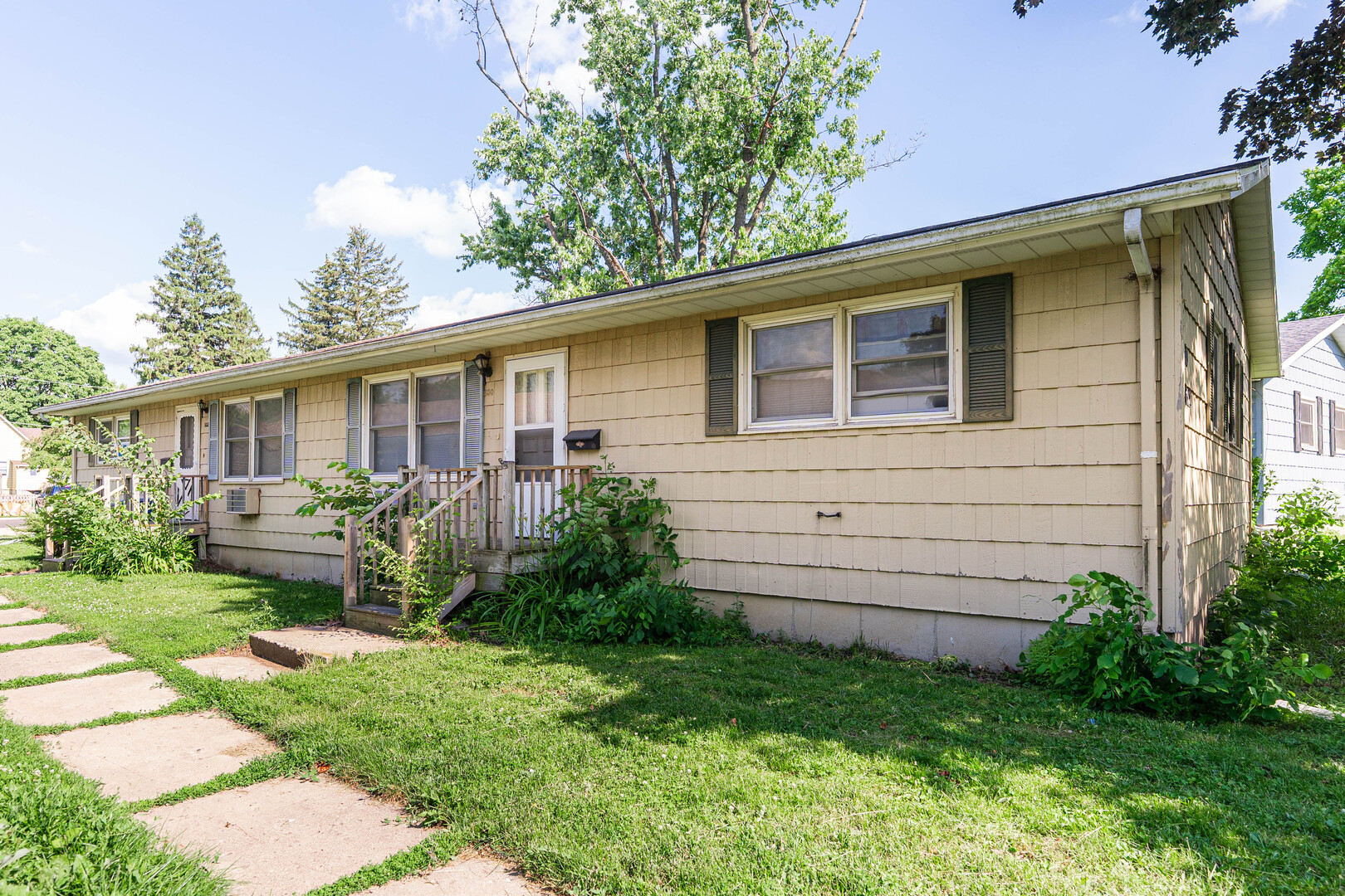 a front view of house with a garden and patio
