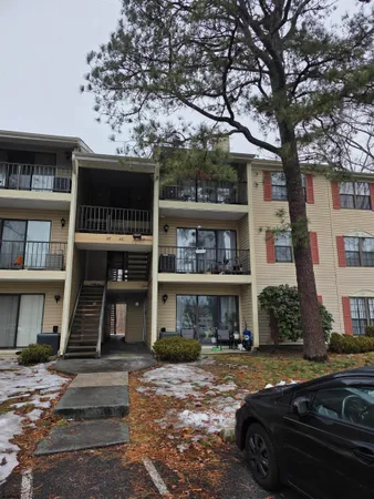 a front view of a residential apartment building with a yard