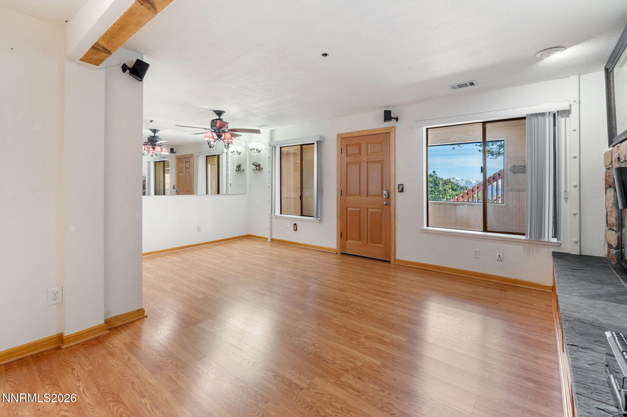 759 Boulder Court, Unit F Stateline, NV 89449 - Photo 4 of 36 a view of an empty room with wooden floor and a window