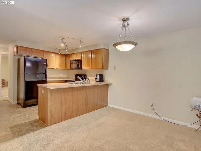 a kitchen with stainless steel appliances a refrigerator sink and stove