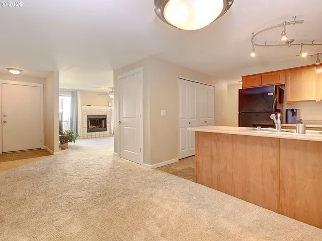 a view of a kitchen with a sink and a refrigerator
