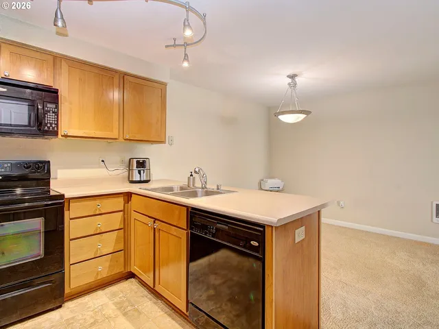 a kitchen with a sink cabinets and appliances
