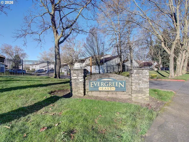 a view of a park that has bench and trees