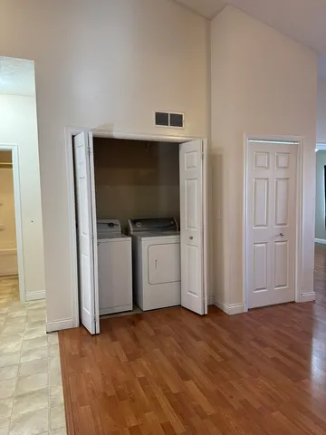a view of a livingroom with wooden floor and cabinet