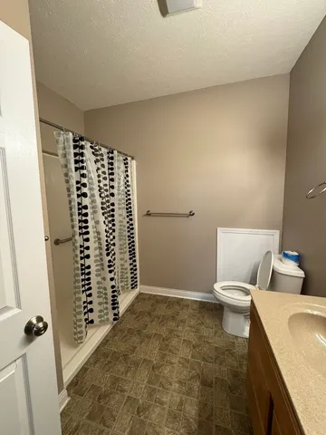 a bathroom with a toilet and shower