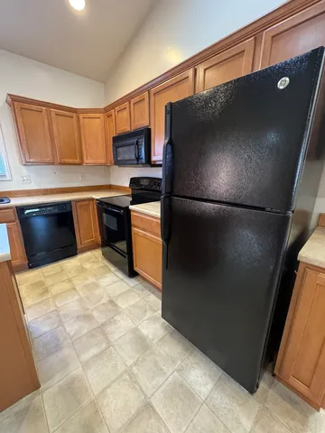 a kitchen with a refrigerator and a stove